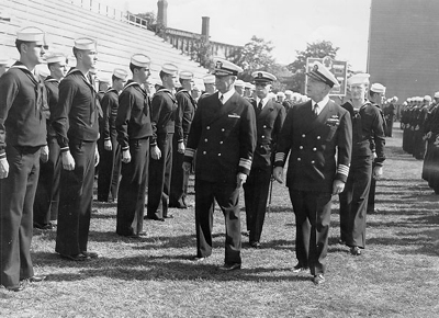 Rear Admiral Theobald conducting an inspection of the Holy Cross Navy Reserve Officer Training Corps