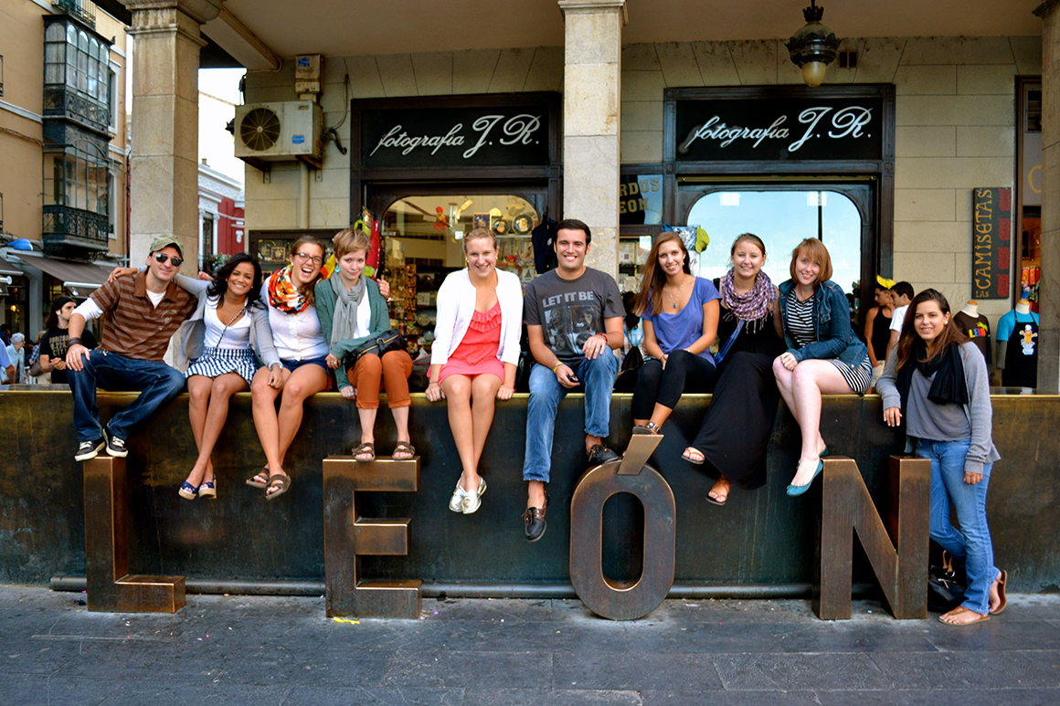 students in front of a LEON sign