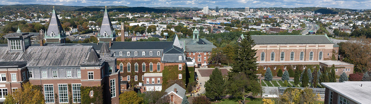 Aerial view of Holy Cross campus with Worcester skyline in the background
