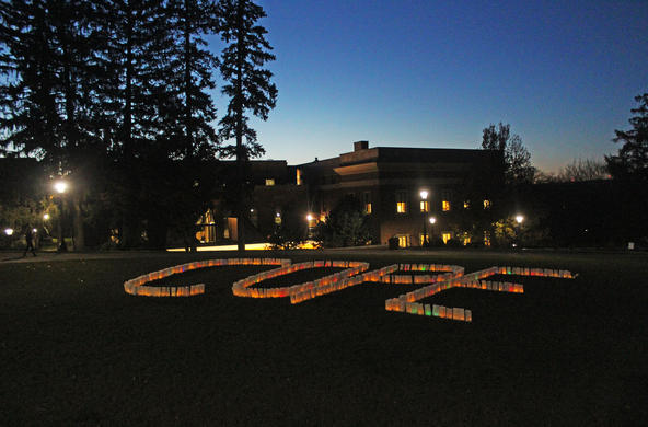 The word COPE spelled out in lights on a dark night.