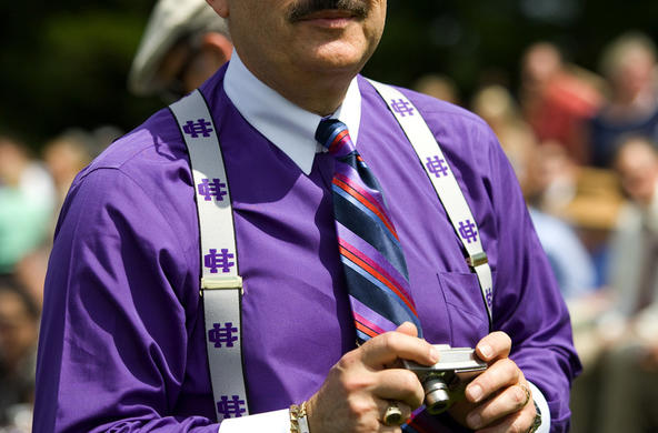 Man wearing purple shirt with Holy Cross suspenders