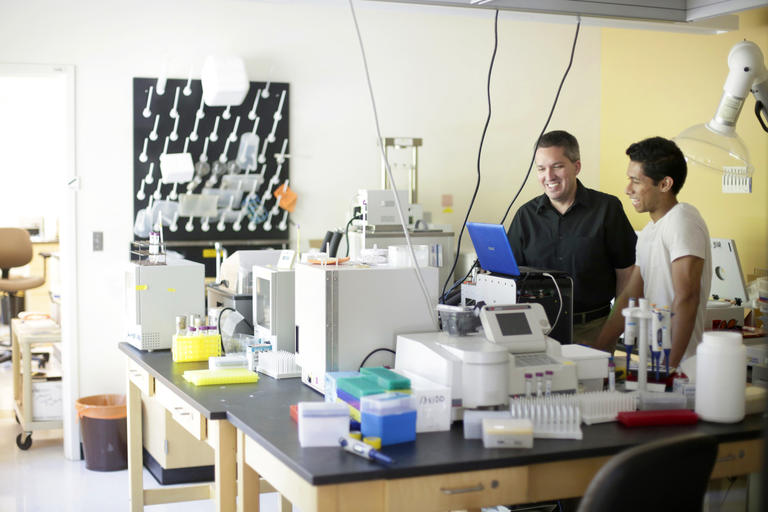 students and faculty working in a lab