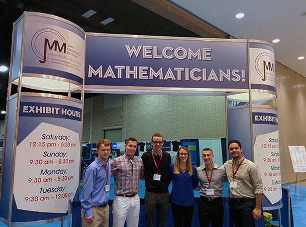 students posing for a photo while attending a mathematics conference