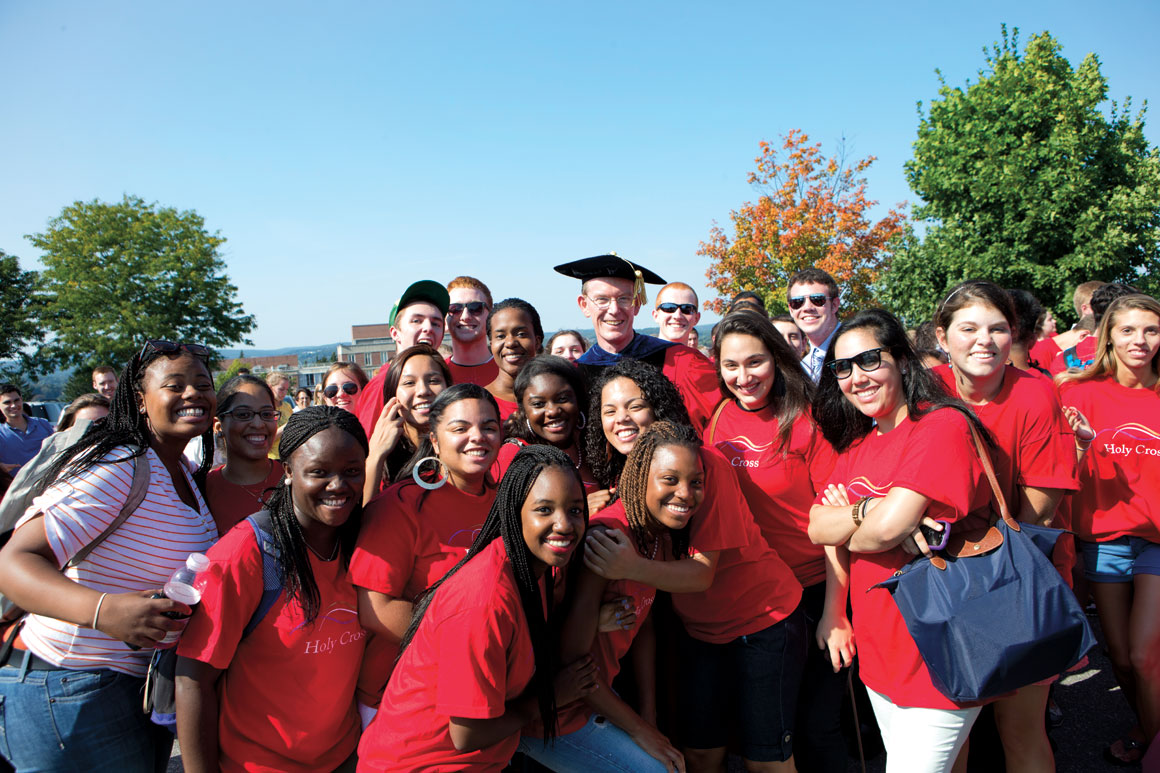 Fr. Boroughs, president of Holy Cross, is surrounded by smiling students on his Inauguration Day, Sept. 14, 2012. 