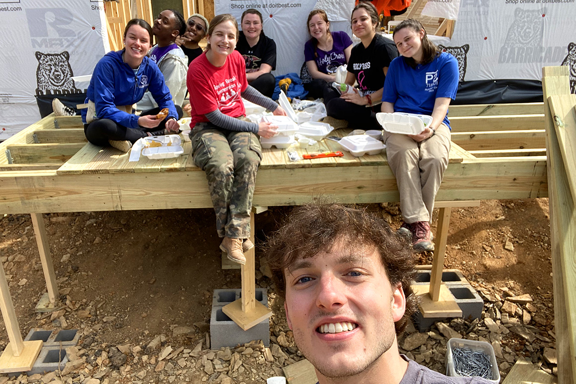 Students taking a lunch break at a construction site as part of an immersion program. 