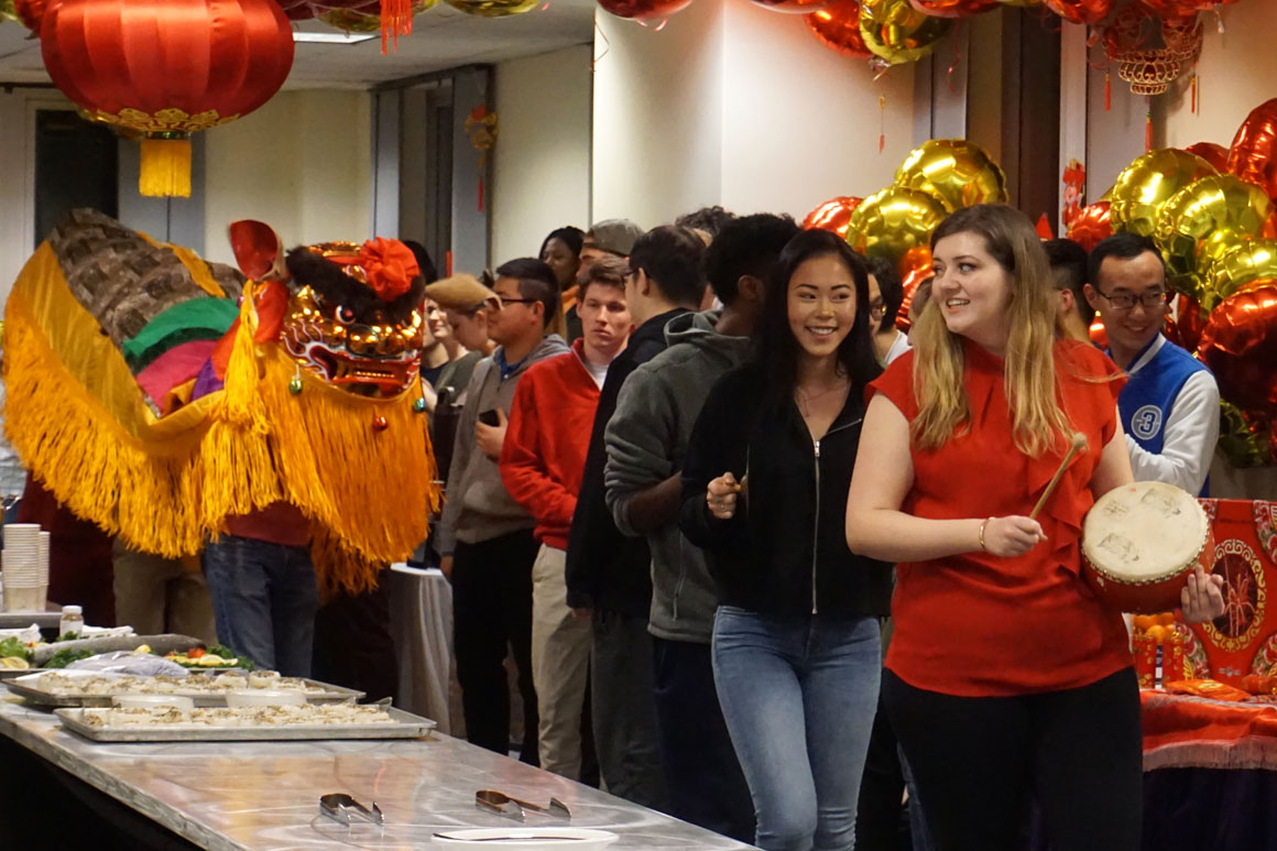 Students take part in a lion procession as part of the Chinese New Year Party on campus.