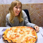 francescabruzzese at a table with a pizza