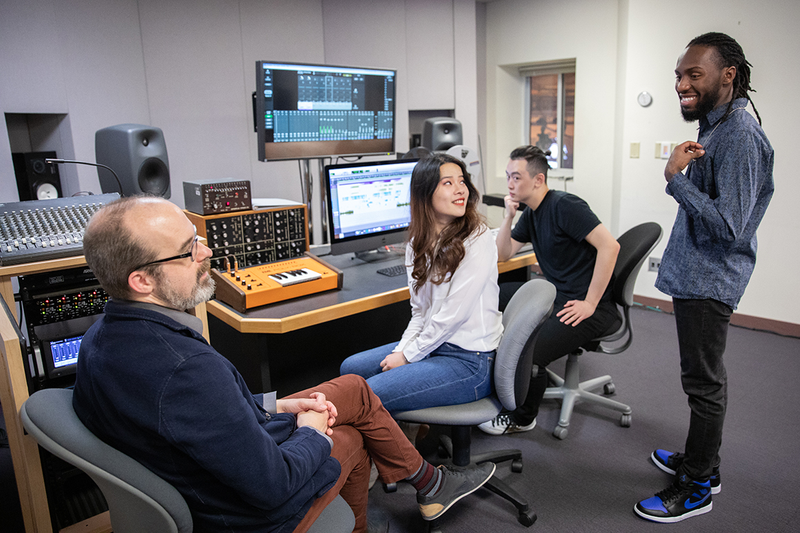 Faculty interacting with students in Brooks Recording Studio 