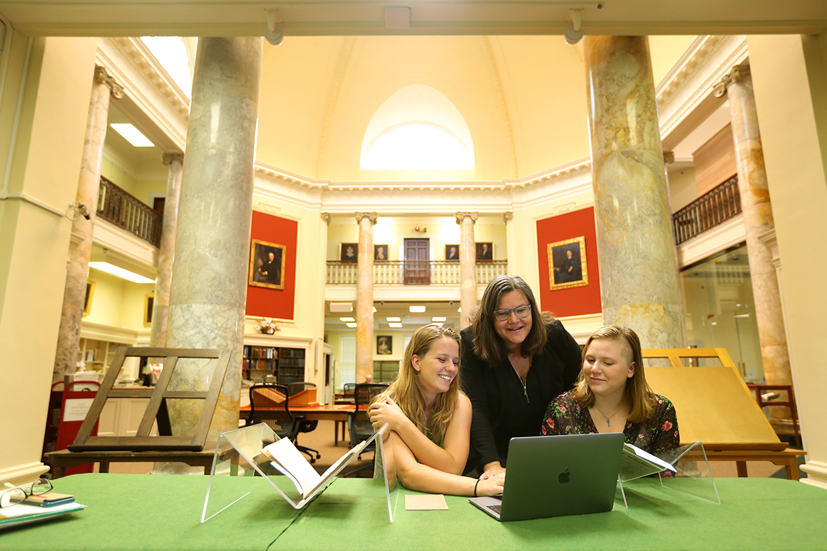 Stephanie Yuhl, professor of history, works with Carly Priest '18, left, and Emily Breakell ’17 on a summer research project. 