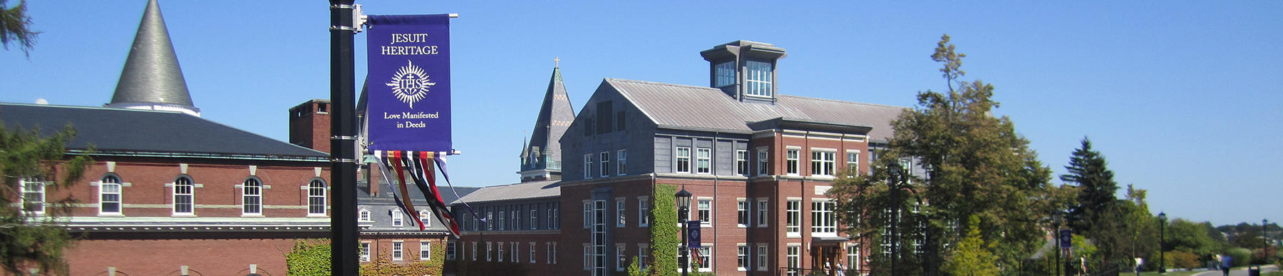 image of smith hall, okane and fenwick hall with a purple jesuit heritage banner