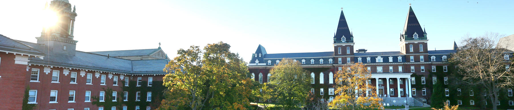 The tops of Alumni Hall and Fenwick Hall as seen during sunrise. 