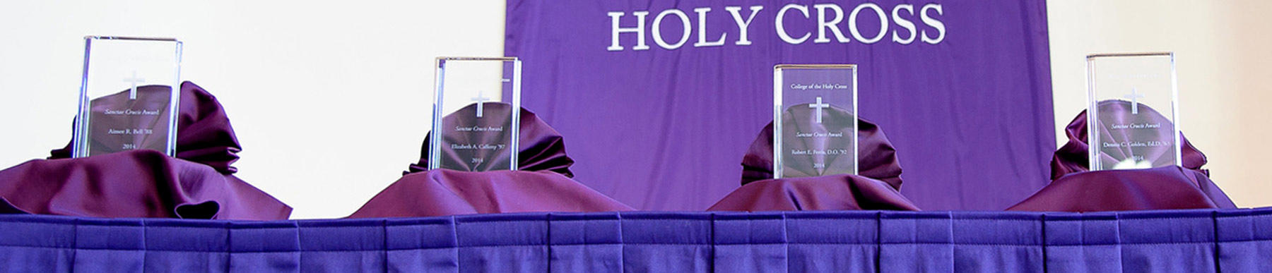 Four Sanctae Crucis awards sitting on a table 