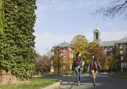 two students walking in Kimball Quad during fall