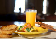 Omelet with toast and glass of orange juice.