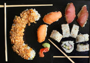 variety of sushi framed by chopsticks
