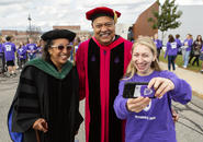 President Rougeau and his wife posing for a photo with a student during inauguration.