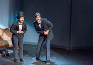 A London stage.  Two entertainers (Mr. Memory and the emcee) in formal suits talk to the audience.