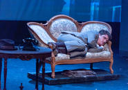 A London apartment.  Richard Hannay is asleep on his Victorian sofa.