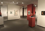 Installation view of center of the gallery with several works by Elizabeth Catlett, including the print 'Sharecropper' and sculpture 'Magic Mask'.