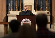 Dmitry Muratov delivers a keynote address from a podium in St. Joseph Memorial Chapel, October 6, 2022.