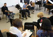 Visual arts students at Burncoat High respond to music performed by Elena Wang '20 and Silkroad musicians