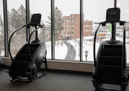 Exercise equipment in The Jo with views of upper campus through the windows