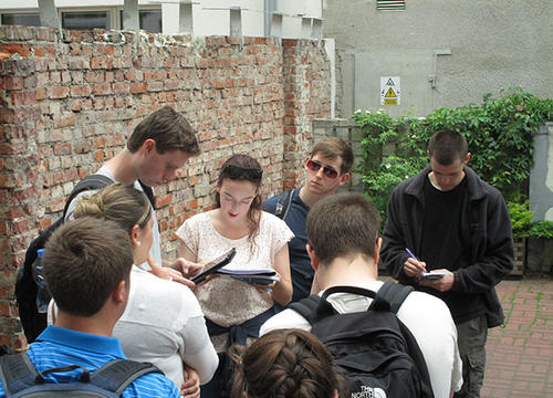 Students gather at the one of the few remaining sections of the Warsaw Ghetto Wall that was erected to seal off the Warsaw Ghetto, the largest ghetto in Poland, on a Maymester trip through central Europe.