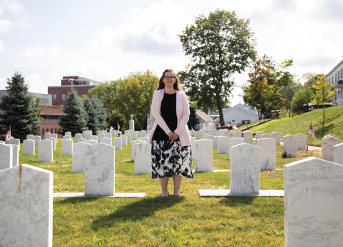 Sarah Campbell stands in the Jesuit Cemetery on campus