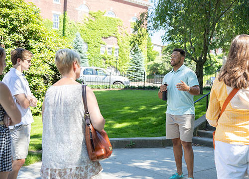 A student leads a tour of campus