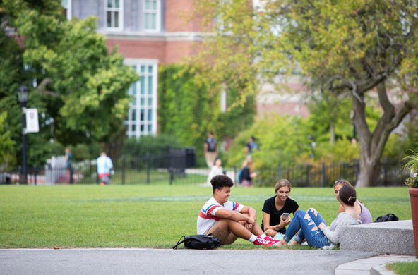 group of students sitting on the ground in the Hogan Courtyard