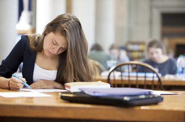 student studying in Dinand Library's Main Reading Room