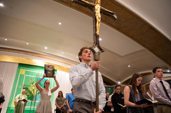 student holding a cross