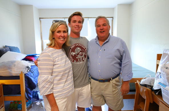 a student flanked by his parents