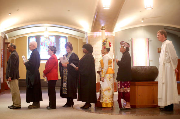 various clergy members from a variety of religions standing in a line