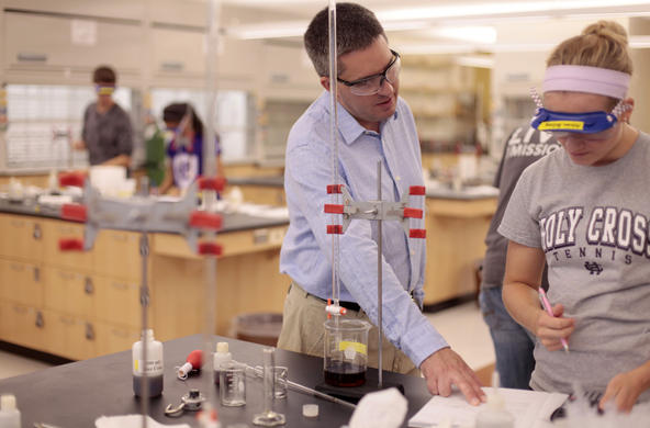 chemistry professor giving a student direction in a science lab