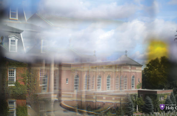 photo through a window of brick building and cemetery 