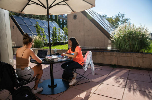 Students sitting at a table outside Dinand library