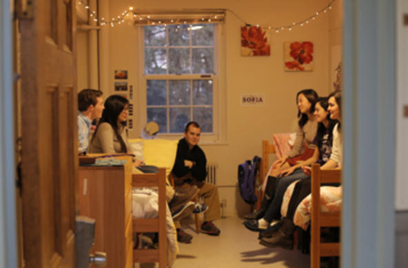 students lounging in a residence hall room