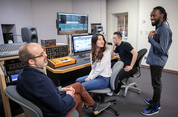 Faculty interacting with students in Brooks Recording Studio