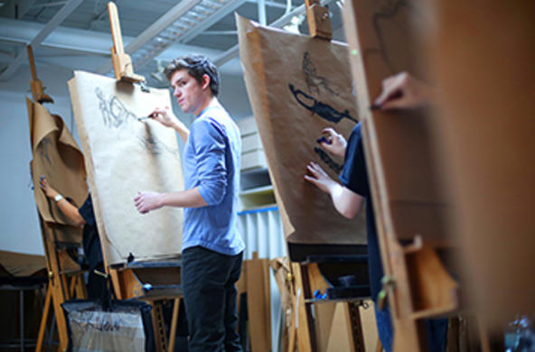 student working at an easel 