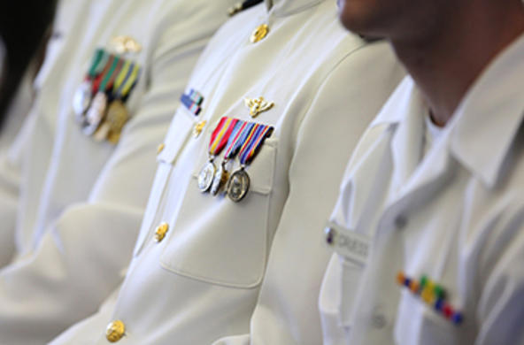 three navy officers in dress whites