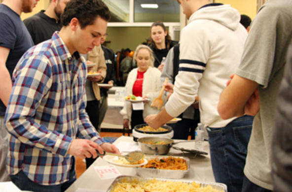 students serving pasta