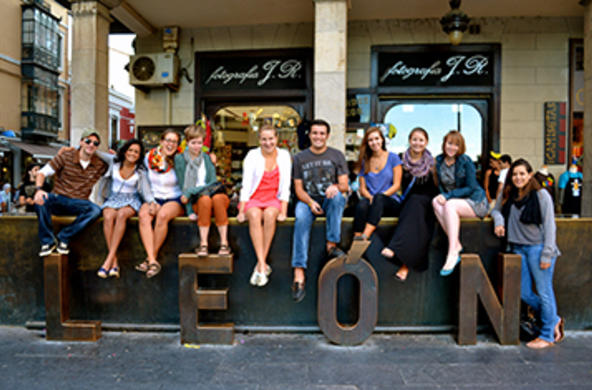 students in front leon sign