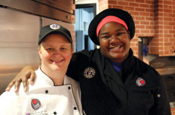 two holy cross dining employees posing for camera