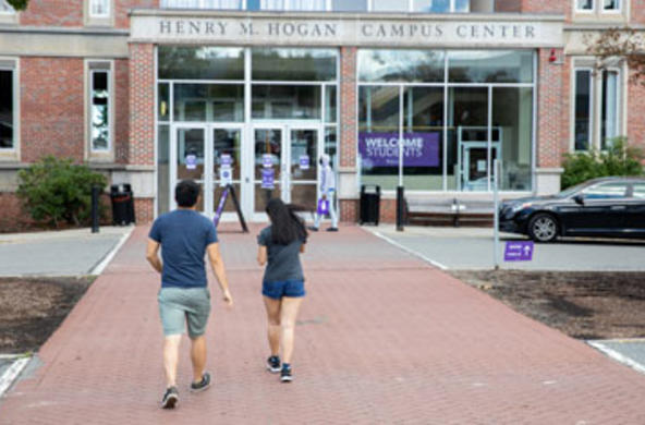 two people walking toward Hogan Campus Center