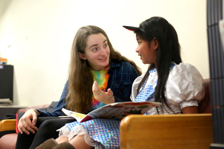 a student talking with a girl as part of community service work