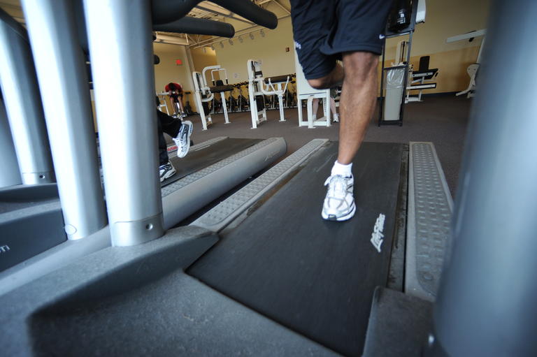 legs of a man on a treadmill