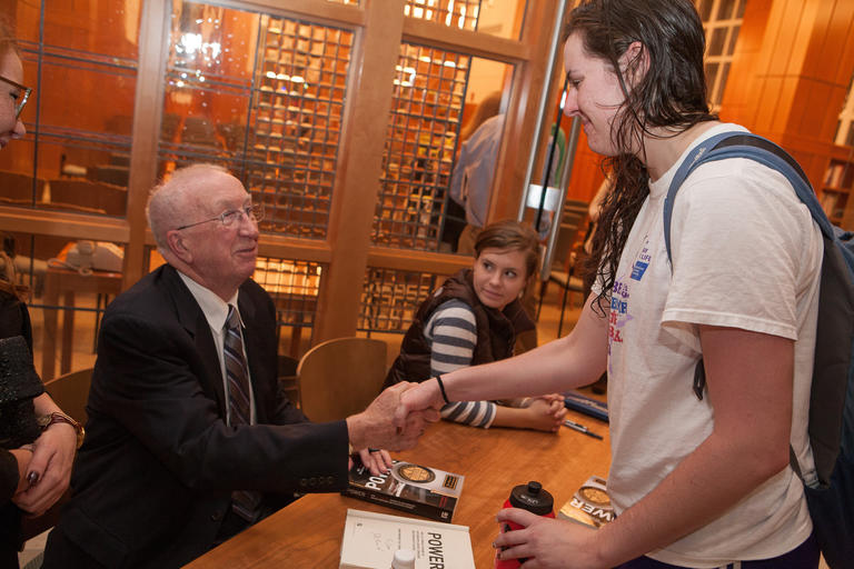 a student shaking the hand of J.D. Power '53