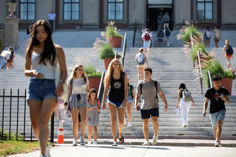 Students walking on campus on a sunny day.