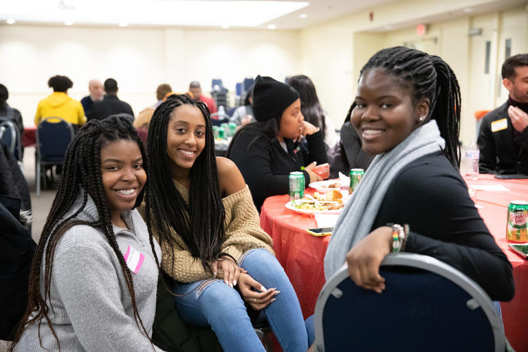 A group of African American female students having dinner in Loyola Hall.